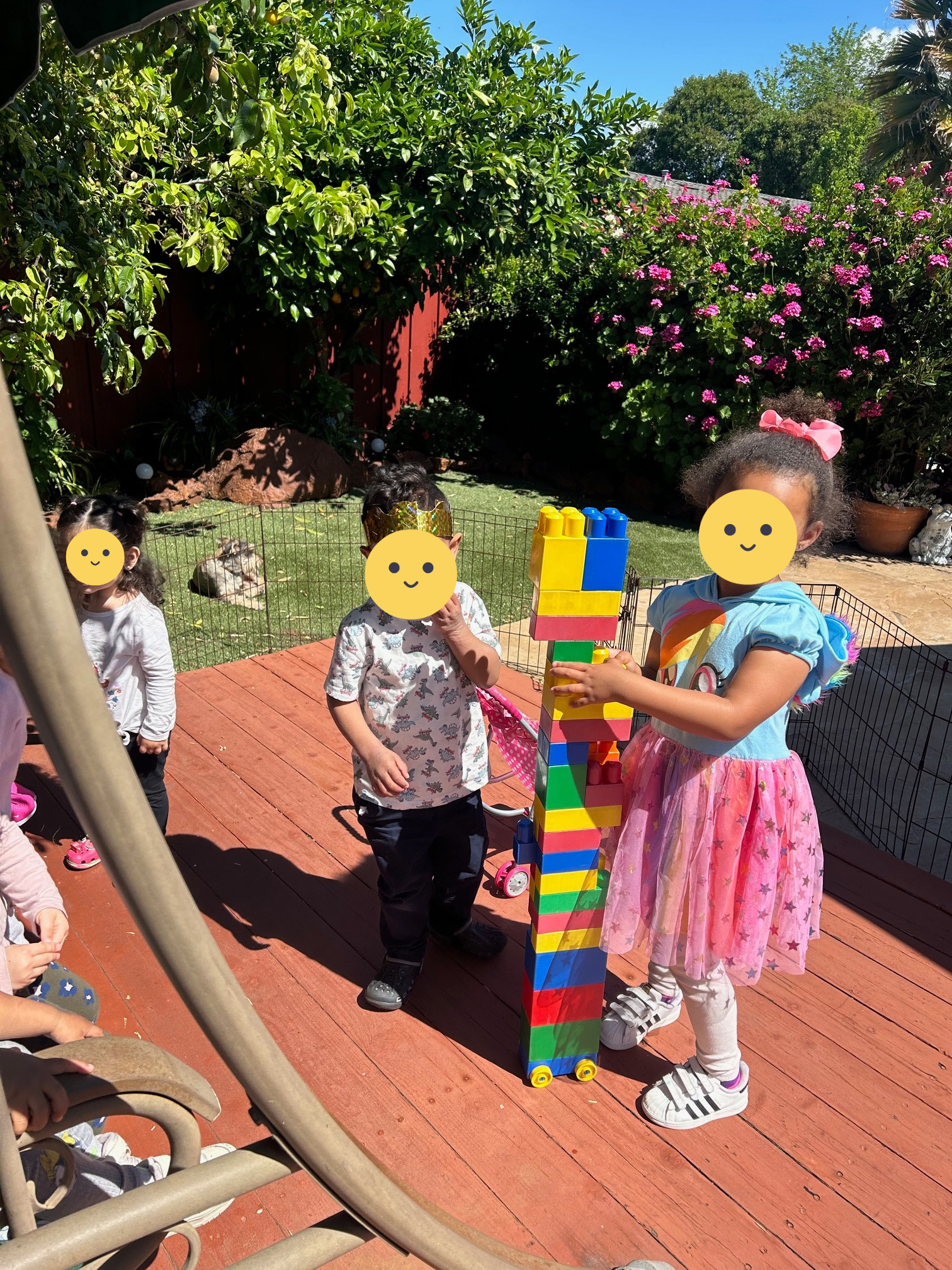 Children playing outside with building blocks.